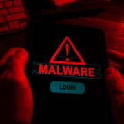 hands in the dark hold a tablet with an inscription malware