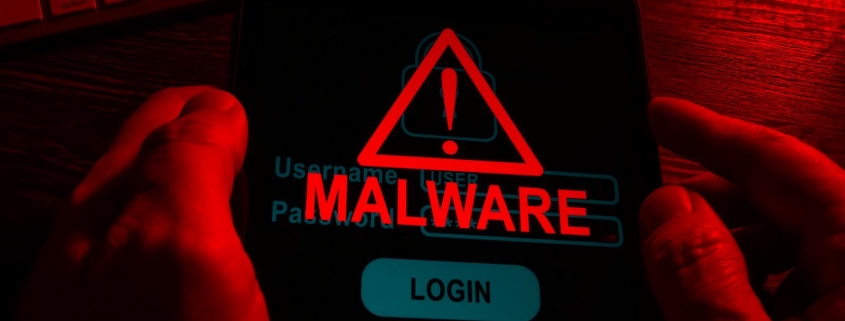 hands in the dark hold a tablet with an inscription malware